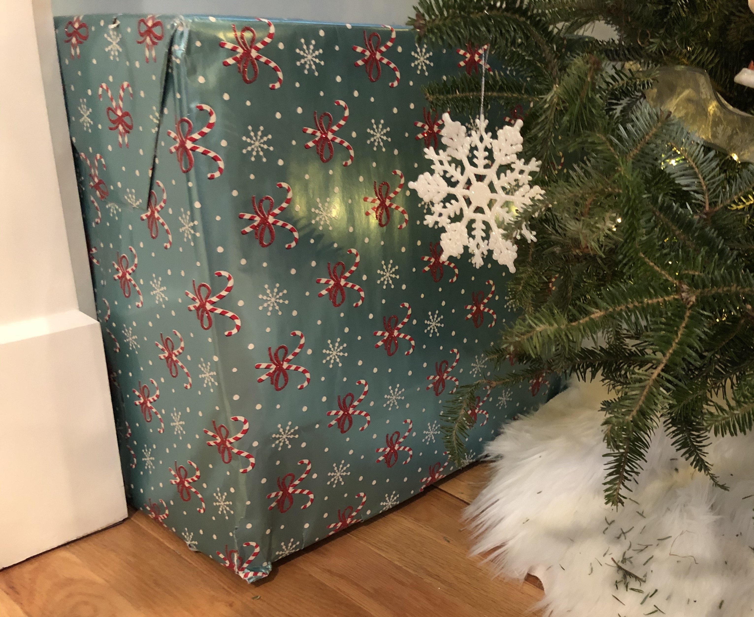 A bucket covered in a box decorated like a present